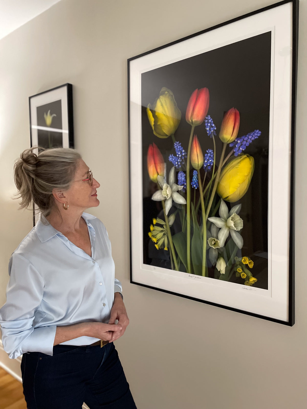 Carmen Grenier photographer, looking at "Spring Bouquet", one of her limited edition fine art prints.